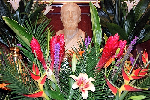 bust of Sri Ramakrishna surrounded by flowers.